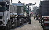 A convoy of trucks carrying humanitarian aid enters the Gaza Strip from Egypt via the Rafah border crossing on October 21, 2023. (Eyad Baba/AFP)