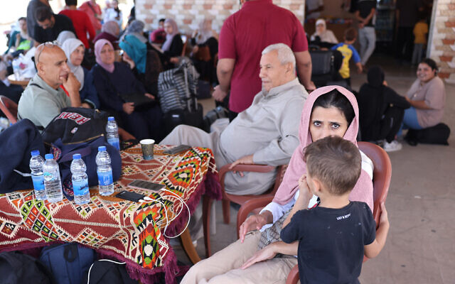 Palestinians with duel citizenship wait outside the Rafah border crossing with Egypt on October 21, 2023, as they wait for permission to cross. (Photo by MOHAMMED ABED / AFP)