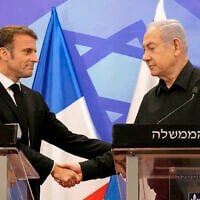 Prime Minister Benjamin Netanyahu (R) shakes hands with French President Emmanuel Macron (L), as they hold a joint press conference in Jerusalem on October 24, 2023. (Christophe Ena/Pool/AFP)