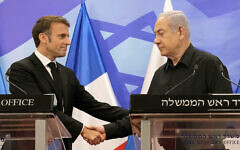 Prime Minister Benjamin Netanyahu (R) shakes hands with French President Emmanuel Macron (L), as they hold a joint press conference in Jerusalem on October 24, 2023. (Christophe Ena/Pool/AFP)