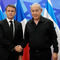 Prime Minister Benjamin Netanyahu (R) greets French President Emmanuel Macron before a meeting in Jerusalem on October 24, 2023. (Christophe Ena/Pool/AFP)