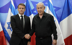 Prime Minister Benjamin Netanyahu (R) greets French President Emmanuel Macron before a meeting in Jerusalem on October 24, 2023. (Christophe Ena/Pool/AFP)