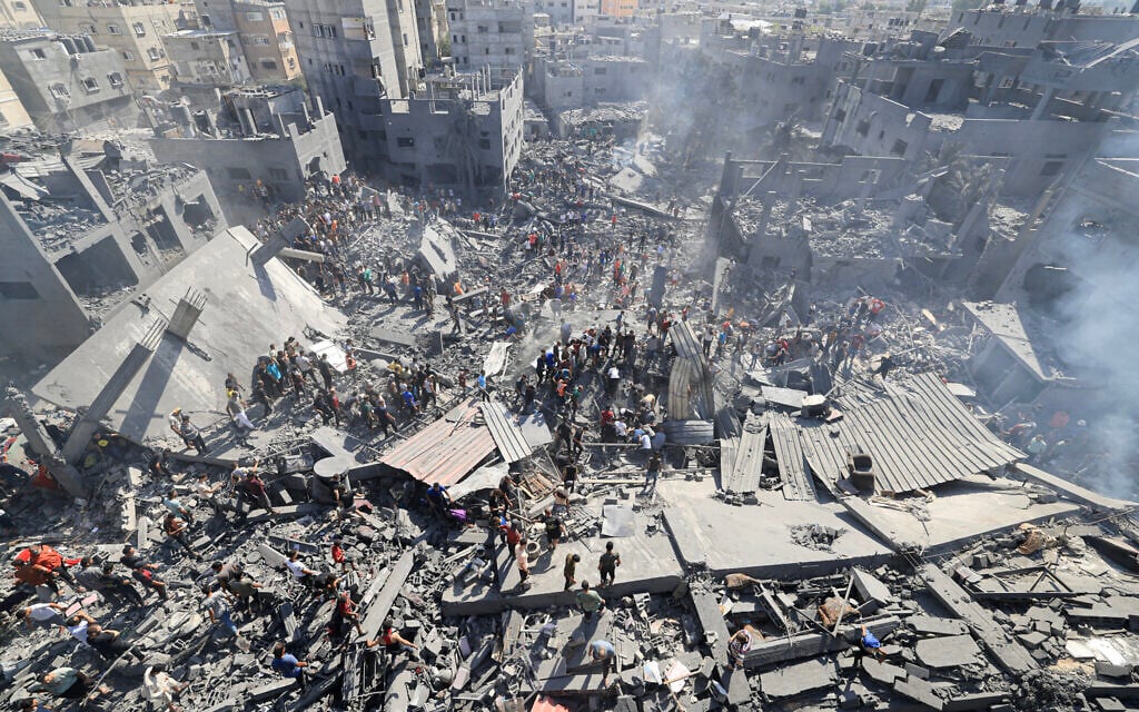 People search for survivors and for bodies of victims through the rubble of buildings destroyed during Israeli airstrikes, in Khan Younis in the southern Gaza Strip, October 26, 2023, amid the ongoing war between Israel and Palestinian terror group Hamas. (Mahmud Hams/AFP) People search for survivors and for bodies of victims through the rubble of buildings destroyed during Israeli airstrikes, in Khan Younis in the southern Gaza Strip, October 26, 2023, amid the ongoing war between Israel and Palestinian terror group Hamas. (Mahmud Hams/AFP)