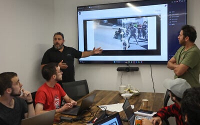 Volunteers search for information on hostages abducted by  Palestinian terrorists on October 7 from a music festival in southern Israel near the border with Gaza, at the offices of Gitam BBDO communications group in Tel Aviv on October 25, 2023 (GIL COHEN-MAGEN / AFP)