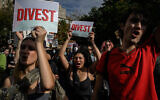 New York University students hold 'Divest' sign as they participate in a walkout during a national day of action called by the Students for Justice in Palestine at Washington Square park in New York on October 25, 2023. (Ed JONES / AFP)