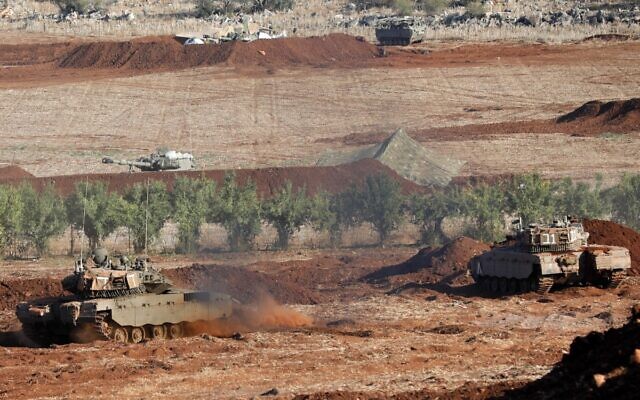 Israeli tanks take part in a military drill near the border with Lebanon in the upper Galilee region, October 26, 2023. (Jalaa Marey/AFP) Israeli tanks take part in a military drill near the border with Lebanon in the upper Galilee region, October 26, 2023. (Jalaa Marey/AFP)