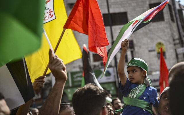 People wave flags of Palestinian groups during a solidarity march with the people of the Gaza Strip, in the West Bank city of Ramallah on October 27, 2023 (Aris MESSINIS / AFP) People wave flags of Palestinian groups during a solidarity march with the people of the Gaza Strip, in the West Bank city of Ramallah on October 27, 2023 (Aris MESSINIS / AFP)