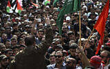 A Palestinian man flashes the victory sign during a solidarity march with the Gaza Strip, in the West Bank city of Ramallah on October 27, 2023, amid the war between Israel and Gaza-ruling Hamas terror group. (Aris Messinis/AFP)