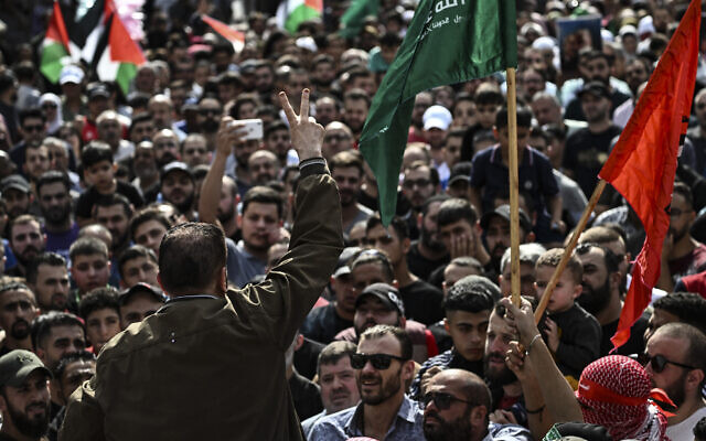 A Palestinian man flashes the victory sign during a solidarity march with the Gaza Strip, in the West Bank city of Ramallah on October 27, 2023, amid the war between Israel and Gaza-ruling Hamas terror group. (Aris Messinis/AFP) A Palestinian man flashes the victory sign during a solidarity march with the Gaza Strip, in the West Bank city of Ramallah on October 27, 2023, amid the war between Israel and Gaza-ruling Hamas terror group. (Aris Messinis/AFP)