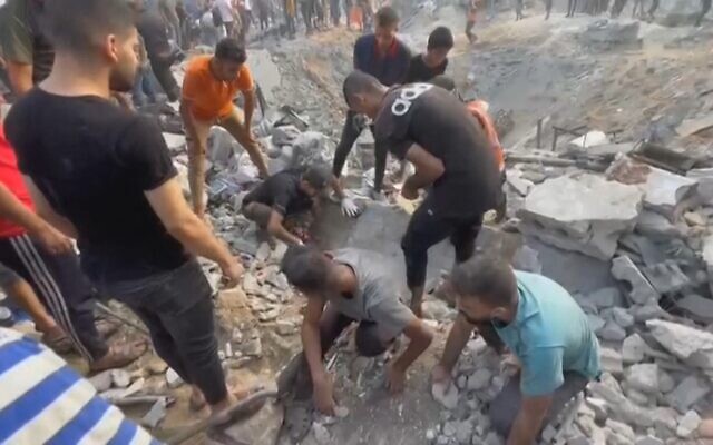 This image grab taken from AFPTV video footage shows Palestinians looking for survivors in a crater following a strike in Jabaliya in the northern Gaza Strip, on October 31, 2023. The IDF said the airstrike was part of 'a wide-scale strike' on Hamas operatives and infrastructure belonging to the terror group’s Central Jabaliya Battalion. (Photo by Fadi Alwhidi / AFP) This image grab taken from AFPTV video footage shows Palestinians looking for survivors in a crater following a strike in Jabaliya in the northern Gaza Strip, on October 31, 2023. The IDF said the airstrike was part of 'a wide-scale strike' on Hamas operatives and infrastructure belonging to the terror group’s Central Jabaliya Battalion. (Photo by Fadi Alwhidi / AFP)