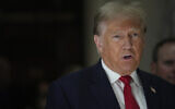 Former US president Donald Trump speaks to reporters as he leaves the courtroom during a lunch break in his civil business fraud trial, October 4, 2023, in New York. (AP Photo/Mary Altaffer)