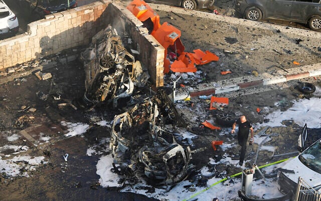 Israeli firefighters extinguish fire after a rocket fired from the Gaza Strip hit a parking lot in Ashkelon, Oct. 7, 2023. (AP Photo/Tsafrir Abayov) Israeli firefighters extinguish fire after a rocket fired from the Gaza Strip hit a parking lot in Ashkelon, Oct. 7, 2023. (AP Photo/Tsafrir Abayov)