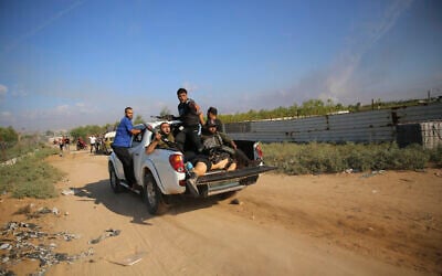 Palestinian terrorists drive to the Gaza Strip with what is believed to be the body of Shani Louk, on October 7, 2023. (AP/Ali Mahmud)
