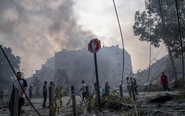 Palestinians inspect the rubble of a building after it was struck by an Israeli airstrike, in Gaza City, October 8, 2023. (AP Photo/Fatima Shbair) Palestinians inspect the rubble of a building after it was struck by an Israeli airstrike, in Gaza City, October 8, 2023. (AP Photo/Fatima Shbair)