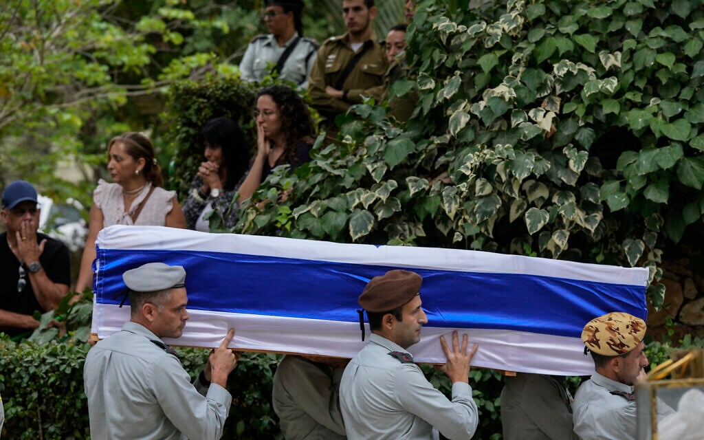 Israeli soldiers carry the flag-covered coffin of Col. Roi Levy during his funeral at the Mount Herzl cemetery in Jerusalem on Monday, Oct. 9, 2023. . (AP Photo/Maya Alleruzzo)