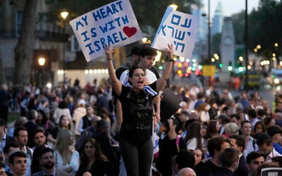 A protester holds posters during the 'Jewish Community Vigil' for Israel in London, October 9, 2023 two days after Hamas fighters launched an unprecedented, multi-front attack on Israel which killed more than 1,000 people. (AP Photo/Kin Cheung)