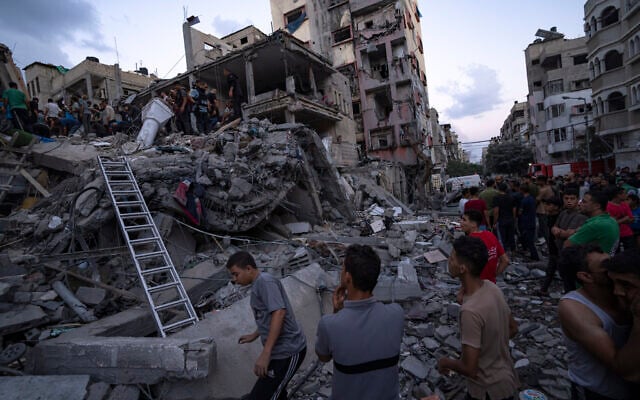 Palestinians look for injured in the rubble of a destroyed building following an Israeli airstrike, Tuesday, Oct. 10, 2023. (AP Photo/Fatima Shbair) Palestinians look for injured in the rubble of a destroyed building following an Israeli airstrike, Tuesday, Oct. 10, 2023. (AP Photo/Fatima Shbair)