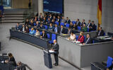 German Chancellor Olaf Scholz delivers a government statement on the situation in Israel amid a war with Hamas during a meeting of the German federal parliament, Bundestag, at the Reichstag building in Berlin, Germany, October 12, 2023. (Michael Kappeler/dpa via AP)
