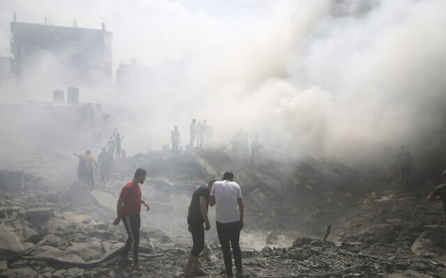 Palestinians look for survivors after an Israeli airstrike in the Rafah refugee camp, southern Gaza Strip, Thursday, Oct. 12, 2023. (AP/Hatem Ali)