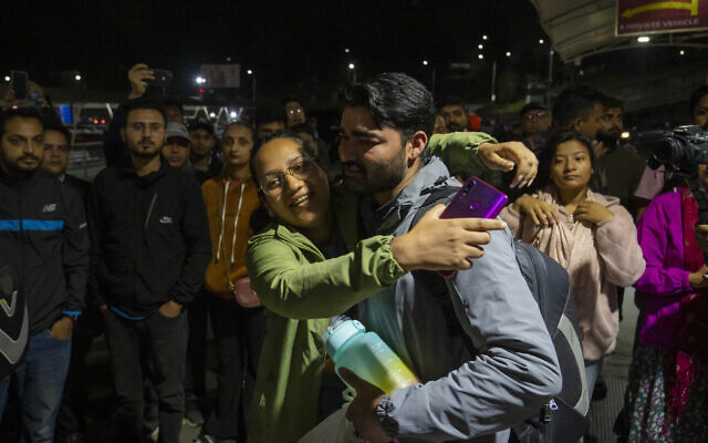 A Nepalese woman welcomes her family member evacuated from Israel at the Tribhuvan International Airport in Kathmandu, Nepal, Friday, Oct. 13, 2023. (AP Photo/Niranjan Shrestha)