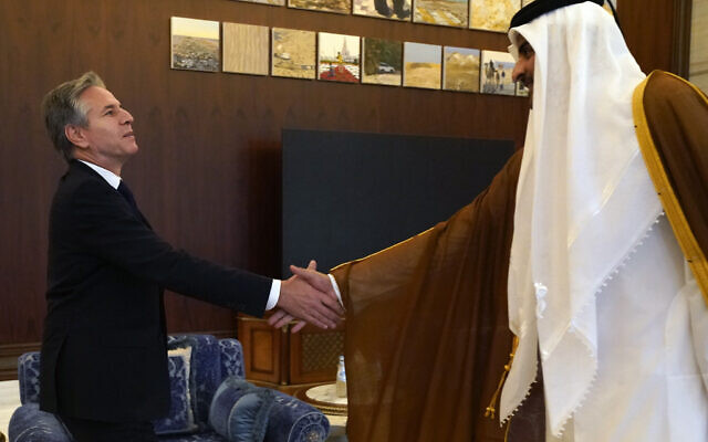 US Secretary of State Antony Blinken, left, and Qatari Emir Sheikh Tamim bin Hamad Al Thani shake hands before their meeting in Lusail, Qatar, Friday Oct. 13, 2023. (AP Photo/Jacquelyn Martin, Pool)