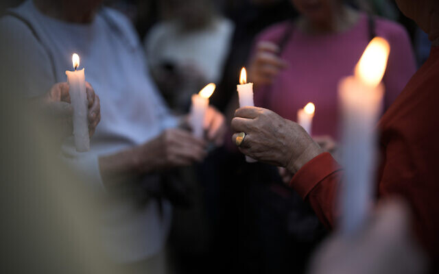 People hold candles as they attend a vigil in front of a synagogue in Berlin, Germany, Friday, Oct. 13, 2023. (Markus Schreiber/AP)