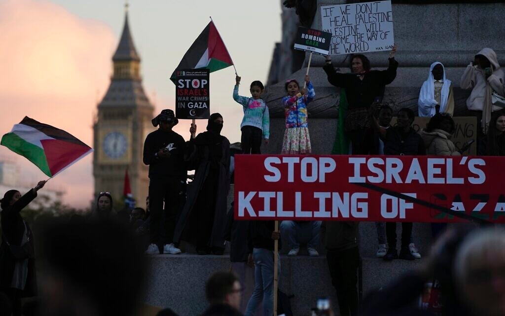 Protesters wave flags as they attend a pro Palestinian demonstration in London, October 14, 2023, in support of Palestinians caught up in the war between Israel and Hamas. (AP Photo/Kin Cheung)