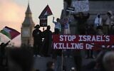 Protesters wave flags as they attend a pro Palestinian demonstration in London, October 14, 2023, in support of Palestinians caught up in the war between Israel and Hamas. (AP Photo/Kin Cheung)