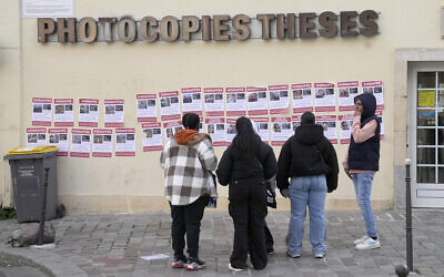 People look at images showing hostages held by terrorists in Gaza, on posters hung by the UEJF (Union of Jewish French Students), in Paris, France, October 16, 2023. (AP Photo/Michel Euler) People look at images showing hostages held by terrorists in Gaza, on posters hung by the UEJF (Union of Jewish French Students), in Paris, France, October 16, 2023. (AP Photo/Michel Euler)