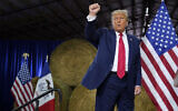Former US president Donald Trump reacts after a "commit to caucus" rally, October 16, 2023, in Adel, Iowa. (AP Photo/Charlie Neibergall)
