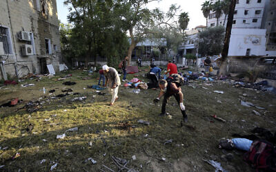 Palestinians check the site of a deadly explosion near Al-Ahli Baptist Hospital in Gaza City, October 18, 2023. (AP Photo/Abed Khaled)