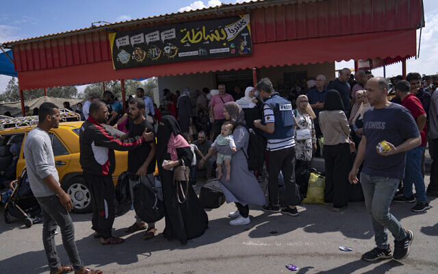 Palestinians wait to cross into Egypt at the Rafah border crossing in the Gaza Strip, October 16, 2023. (Fatima Shbair/AP) Palestinians wait to cross into Egypt at the Rafah border crossing in the Gaza Strip, October 16, 2023. (Fatima Shbair/AP)
