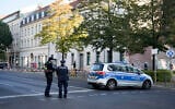German police officers stand guard in front of the building complex of the Kahal Adass Jisroel community, which houses a synagogue, a kindergarten and a community center, in the center of Berlin, Germany, October 18, 2023. (AP/Markus Schreiber)