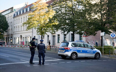 German police officers stand guard in front of the building complex of the Kahal Adass Jisroel community, which houses a synagogue, a kindergarten and a community center, in the center of Berlin, Germany, October 18, 2023. (AP/Markus Schreiber)