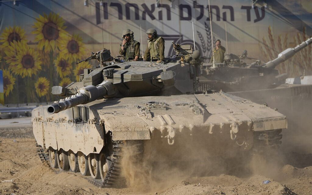 Israeli soldiers move a tank at a staging area near the border with Gaza Strip, in southern Israel on October 15, 2023. (AP Photo/Ohad Zwigenberg) Israeli soldiers move a tank at a staging area near the border with Gaza Strip, in southern Israel on October 15, 2023. (AP Photo/Ohad Zwigenberg)