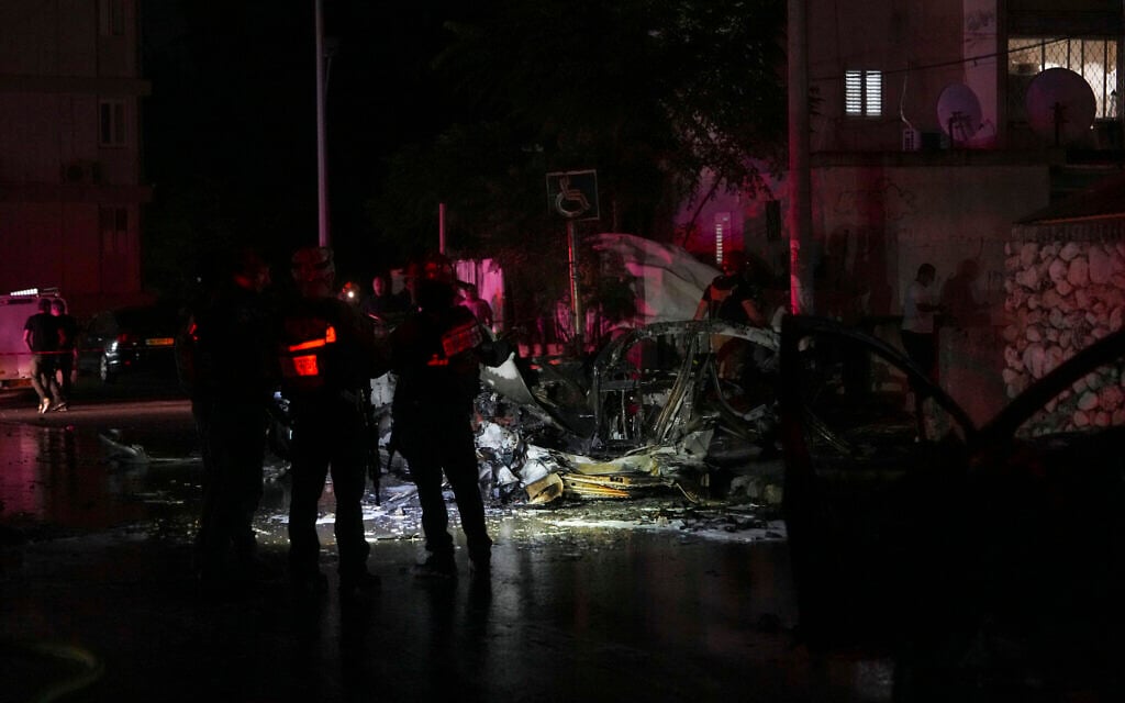 Israeli firefighters and police inspect a site struck by a rocket fired from the Gaza Strip, in Ashkelon, southern Israel, Friday, Oct. 20, 2023. (AP Photo/Tsafrir Abayov)