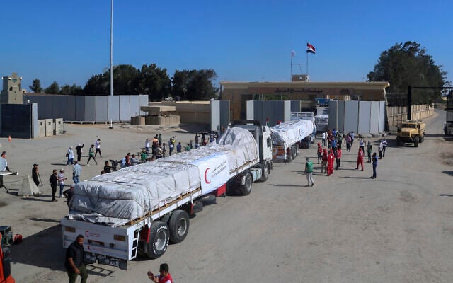 Trucks of Egyptian Red Crecent carrying humanitarian aid for the Gaza Strip cross the Rafah border gate, in Rafah, Egypt, October 21, 2023. (Mohammed Asad/AP) Trucks of Egyptian Red Crecent carrying humanitarian aid for the Gaza Strip cross the Rafah border gate, in Rafah, Egypt, October 21, 2023. (Mohammed Asad/AP)
