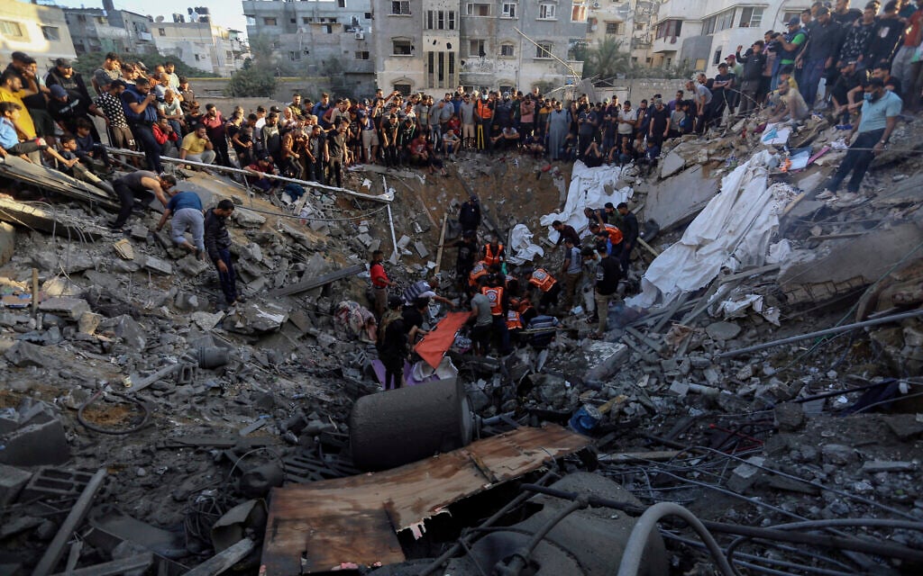 Palestinians gather over the remains of a destroyed house following Israeli airstrikes on Gaza City, Saturday, Oct. 21, 2023. (AP Photo/Abed Khaled)