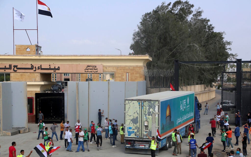 A truck carrying humanitarian aid for the Gaza Strip crosses the Rafah border gate in Rafah, Egypt, October 22, 2023. (AP Photo/ Mohammed Asad)