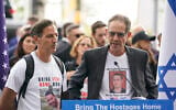 Ronen Nuetra, right, and Ruby Chen, both of whom have sons being held hostage by Hamas, speak during a rally in front of United Nations headquarters in New York, Tuesday, October 24, 2023. (Seth Wenig/AP)