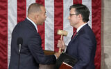 US House Minority Leader Hakeem Jeffries of New York (left) hands the gavel to then-speaker-elect Rep. Mike Johnson, a Louisiana Republican, at the Capitol in Washington, October 25, 2023. (AP Photo/Alex Brandon)