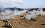 South Korean army K-9 self-propelled howitzers and K-55A1 self-propelled howitzers fire during the military drills at a training field in Cheorwon, South Korea, Oct. 27, 2023. (Yang Ji-woong/Yonhap via AP)