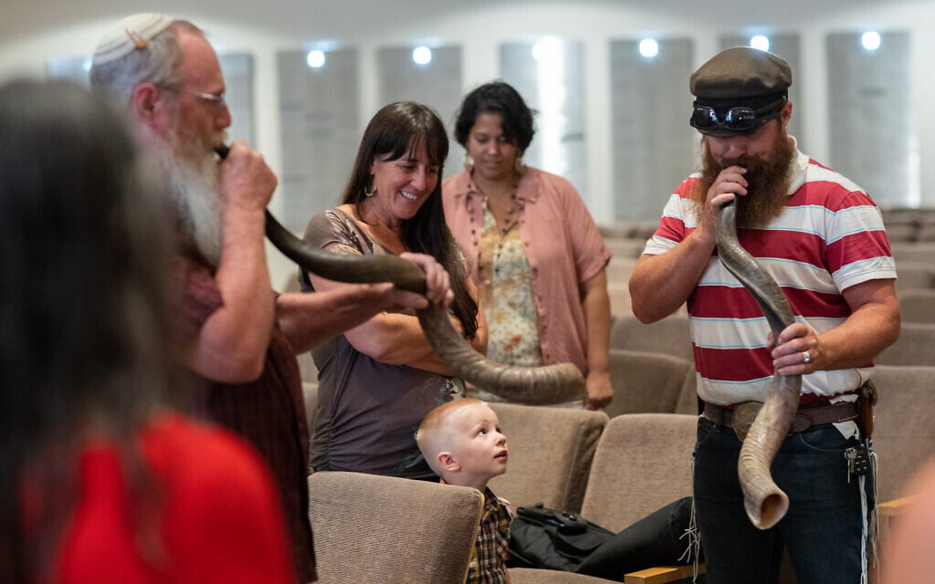 David Most, left, and Joel Most play shofars at Congregation Beth Israel on August 17, 2023 in Paradise Valley, Arizona. ( Caitlin O’Hara via JTA)