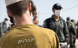 Jewish settlers seen during the demolition of six illegally built structures at the outpost of Kumi Ori, outside the Jewish settlement of Yitzhar, in the West Bank, April 22, 2020. (Sraya Diamant/Flash90)