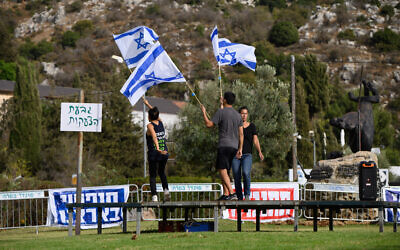 Anti-judicial overhaul activists prepare to demonstrate near a hotel in Neve Ativ, where Prime Minister Benjamin Netanyahu and his wife Sara are planning to vacation, in the Golan Heights, October 1, 2023. (Ayal Margolin/Flash90)