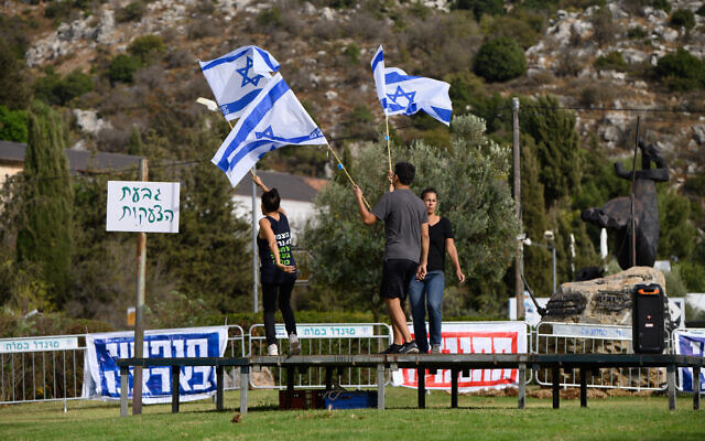 Anti-judicial overhaul activists prepare to demonstrate near a hotel in Neve Ativ, where Prime Minister Benjamin Netanyahu and his wife Sara are planning to vacation, in the Golan Heights, October 1, 2023. (Ayal Margolin/Flash90) Anti-judicial overhaul activists prepare to demonstrate near a hotel in Neve Ativ, where Prime Minister Benjamin Netanyahu and his wife Sara are planning to vacation, in the Golan Heights, October 1, 2023. (Ayal Margolin/Flash90)
