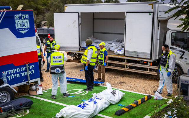 Zaka personnel remove bodies of Israeli civilians near the Gaza border, October 9, 2023 (Yossi Aloni/Flash90) Zaka personnel remove bodies of Israeli civilians near the Gaza border, October 9, 2023 (Yossi Aloni/Flash90)