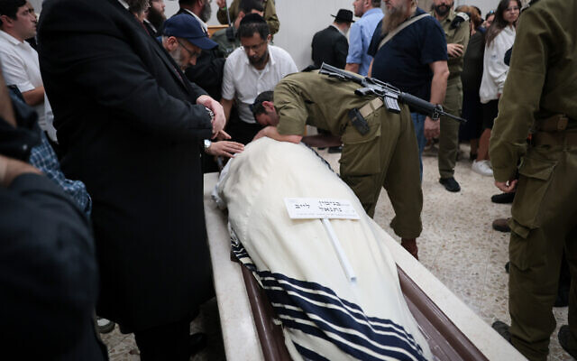 Family and friends attend the funeral of lone soldier Sgt. Benjamin Loeb in Jerusalem. (Noam Revkin Fenton /Flash90) Family and friends attend the funeral of lone soldier Sgt. Benjamin Loeb in Jerusalem. (Noam Revkin Fenton /Flash90)