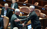 File - Prime Minister Benjamin Netanyahu shakes the hand of then-newly appointed minister Benny Gantz at a special session presenting the new emergency government at the Knesset plenum in Jerusalem, October 12, 2023. (Noam Revkin Fenton/Flash90)