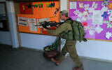 Reserve IDF soldiers training at a school in the Golan Heights, on October 19, 2023. (Michael Giladi/Flash90)